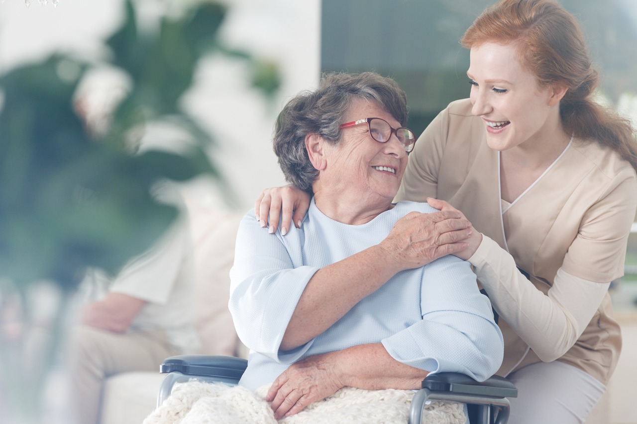 Caregiver embracing an elderly woman